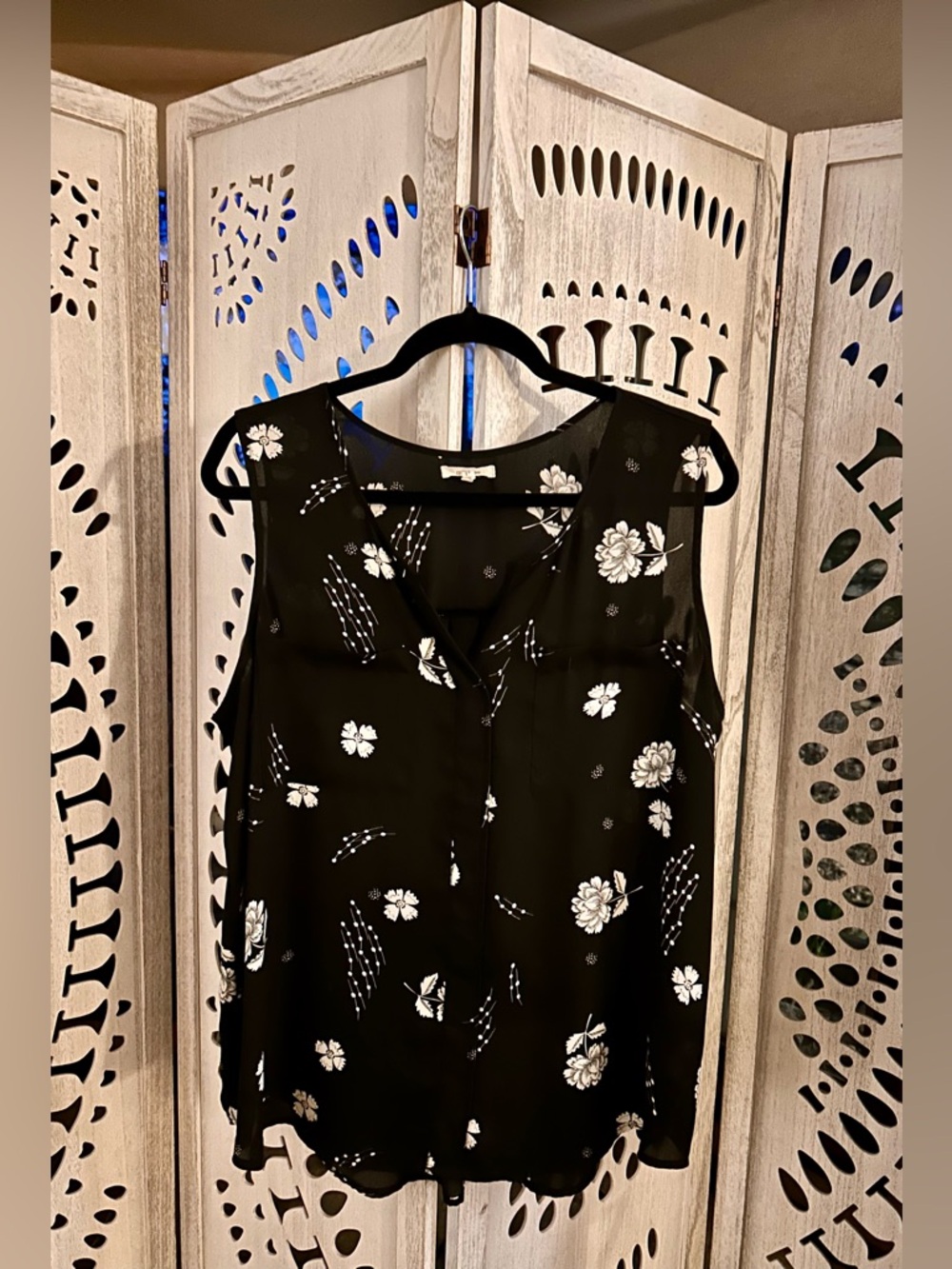 Black and ivory floral sleeveless blouse is from Maurices